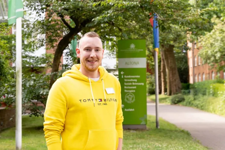 Ole Hansen als Wohnbereichsleiter bei PFLEGEN & WOHNEN HAMBURG vor dem Standort Altona.